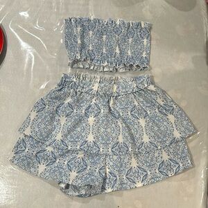 Two piece, strapless top and skort.